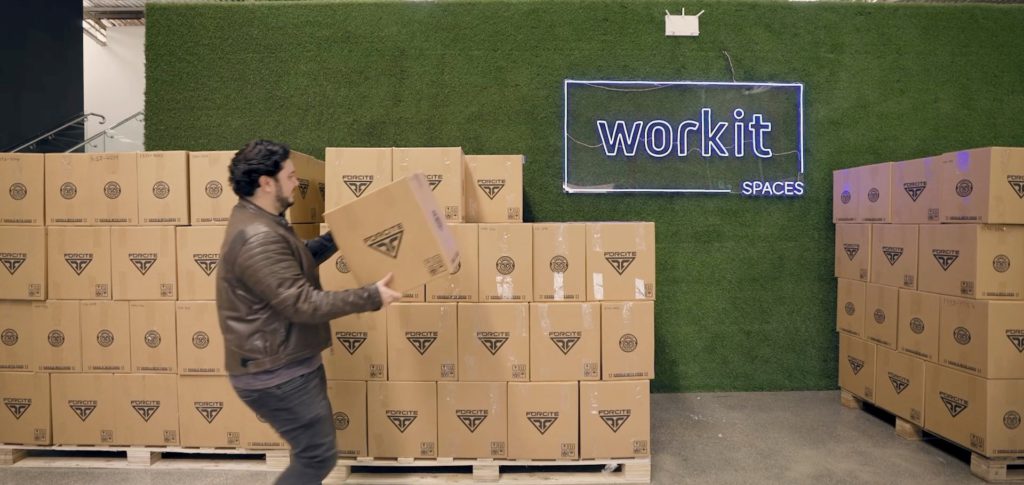 man placing packages on a loading dock